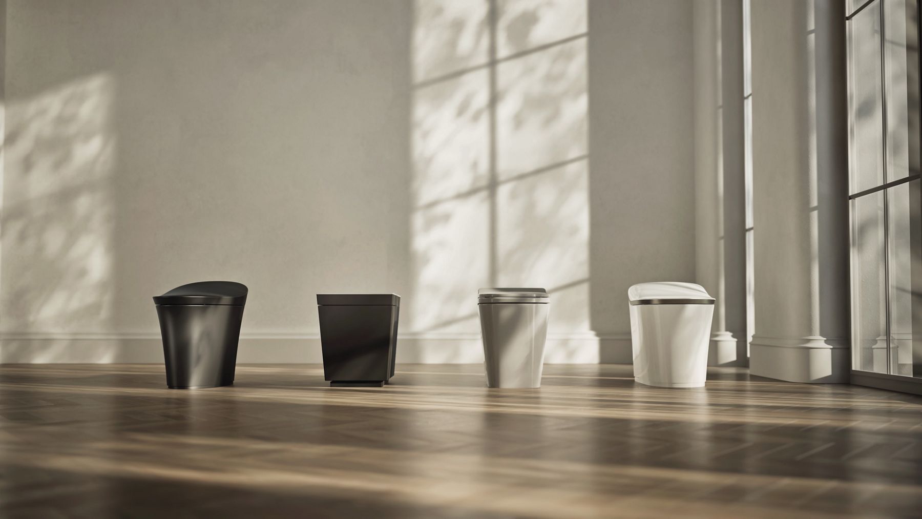 Four smart toilets displayed in a row in different finishes, shown in a sunlit interior space