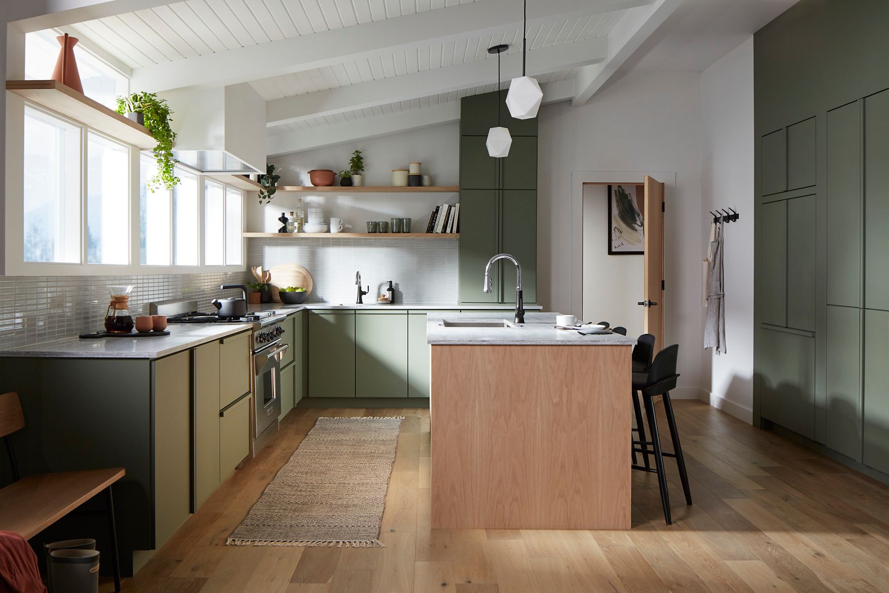 A kitchen with two-tone faucets in matte black and polished chrome with matching accents throughout the space.