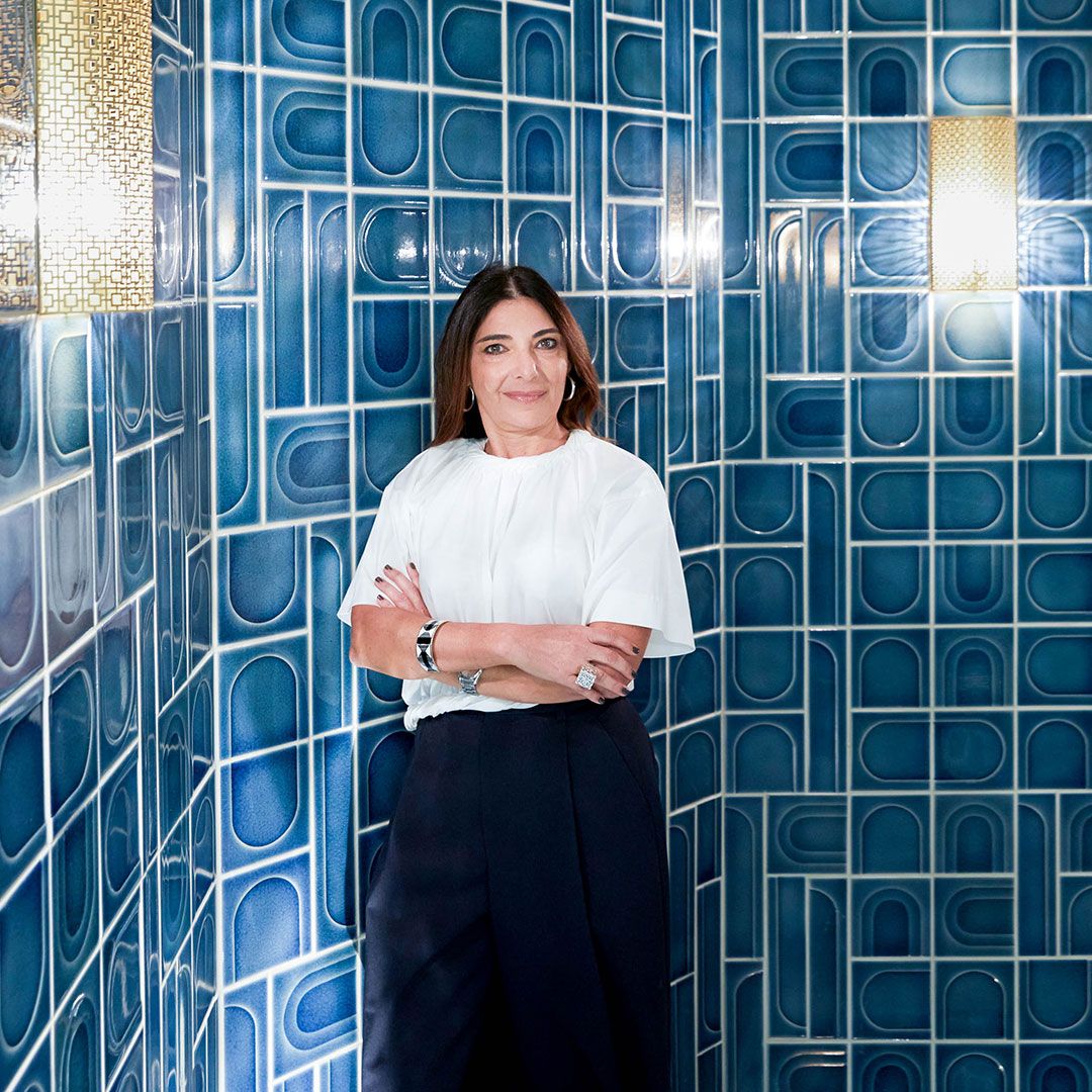 Nada Debs, a designer, in the space she designed using the Waste Lab tiles with arches and vary shades of blue.