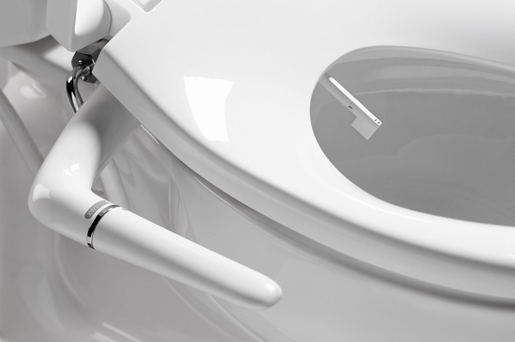 Close-up of KOHLER manual bidet seat with side control and spray nozzle