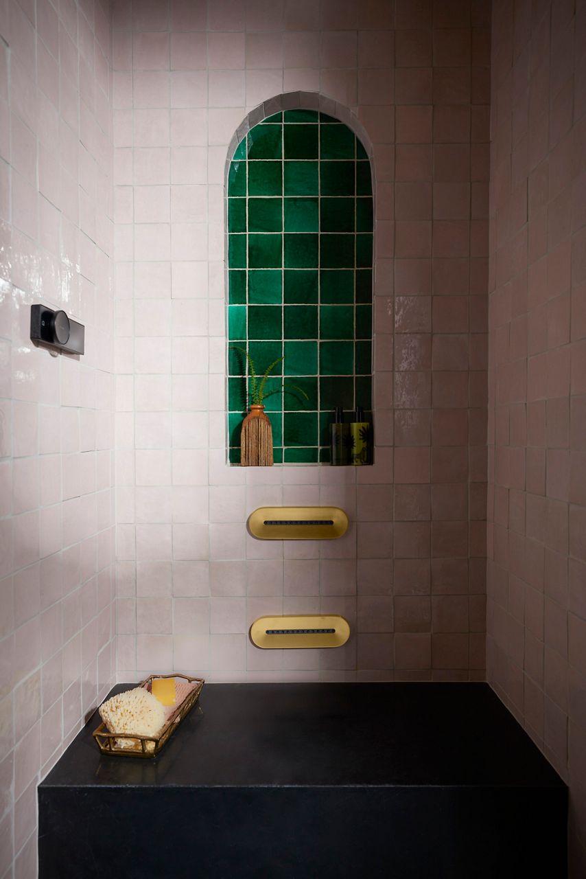Image of the showering area in bathroom designed by Justina Blakeney for Kohler's Heritage Color collection. Image focuses on the Anthem shower controls and shower body sprays, installed against colorful tile walls.