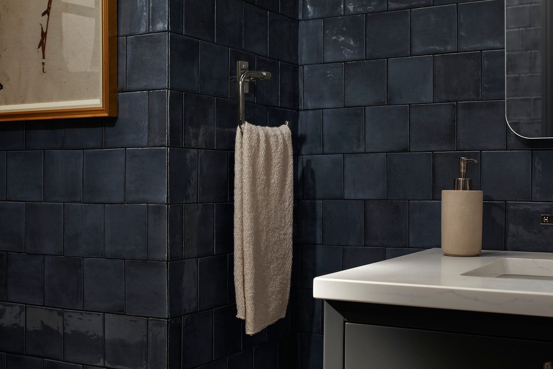A towel arm designed by Shea McGee with a towel on it.