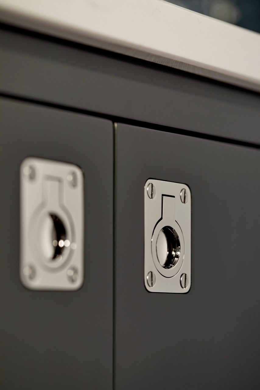 Close up detail of the chrome metal ring-shaped handles on a vanity designed by Shea McGee.