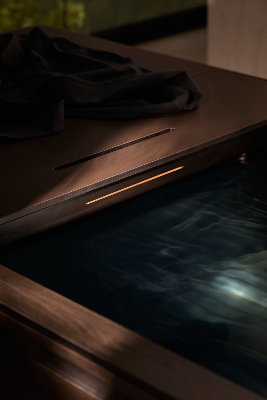 A close up of an ice bath filled with water with towel.