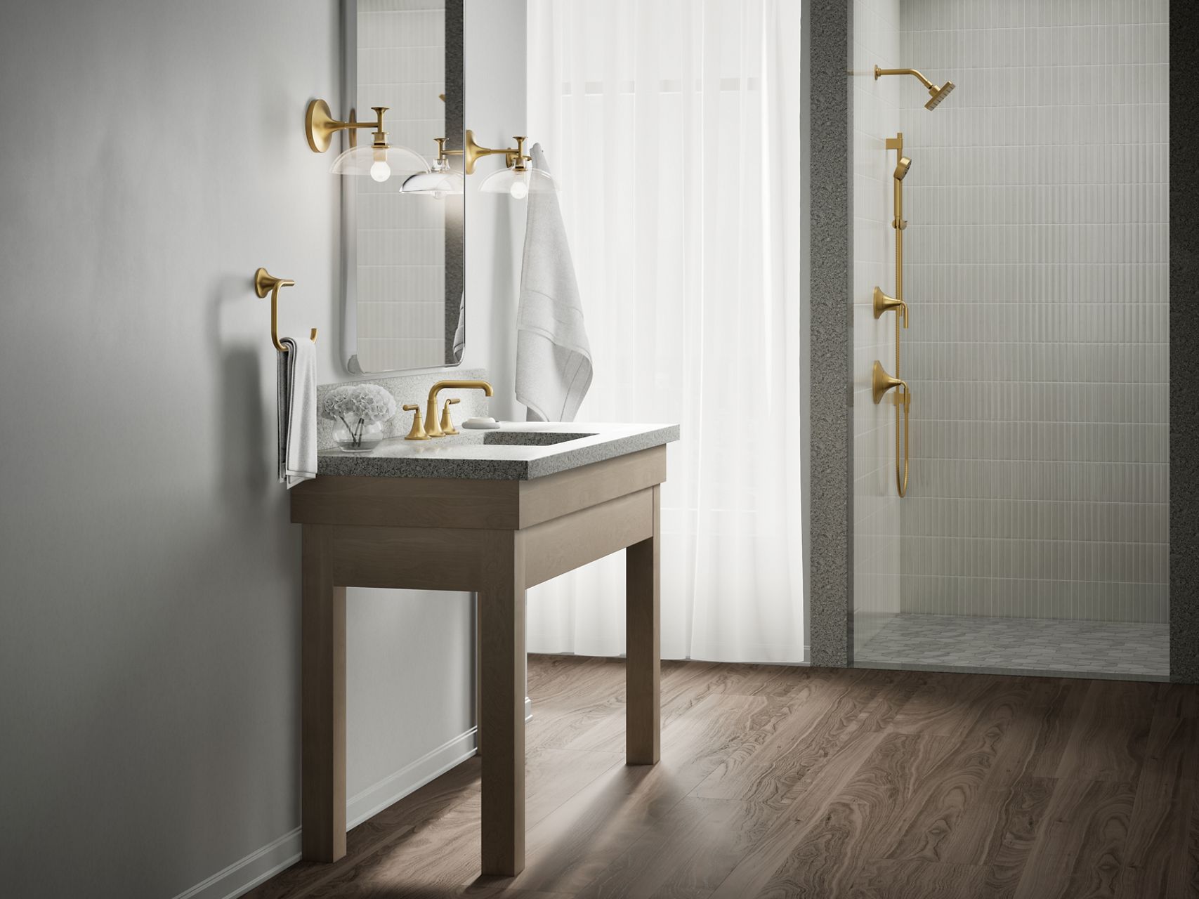 Modern bathroom with a marble bathroom vessel sink and countertop, brushed brass faucet, wall-mounted light fixtures, mirror, towel ring, towel hook, and a coordinating gold showering outlets with white textured tile backdrop.