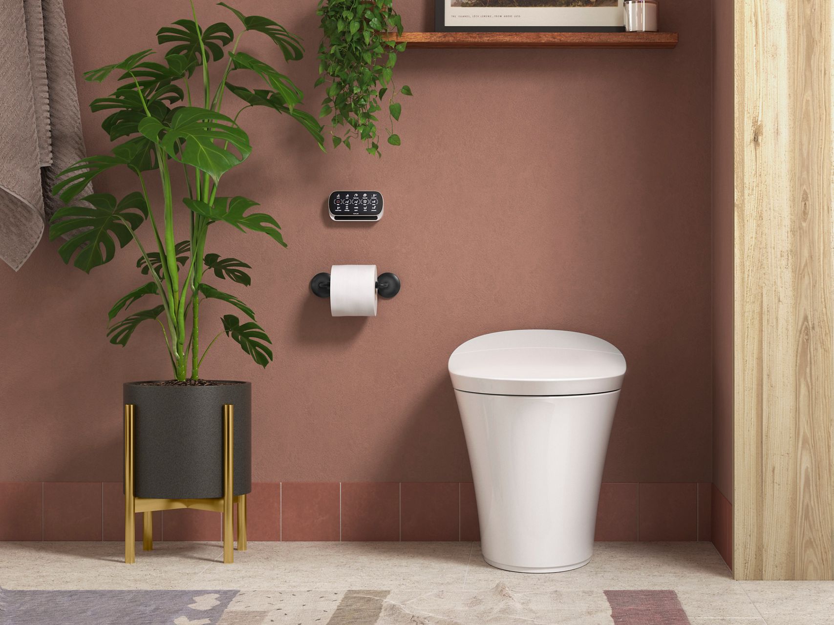 A white, tankless smart toilet next to a plant in front of a terra cotta colored wall.