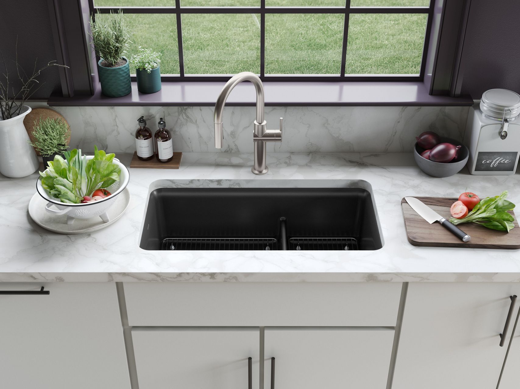 Black double-basin kitchen sink set into a marble countertop beneath a wide window in a bright kitchen.