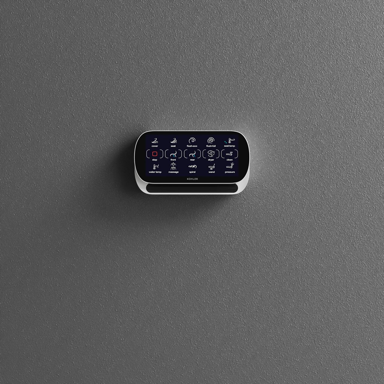 A touchscreen remote control for a smart toilet with the toilet in the background.