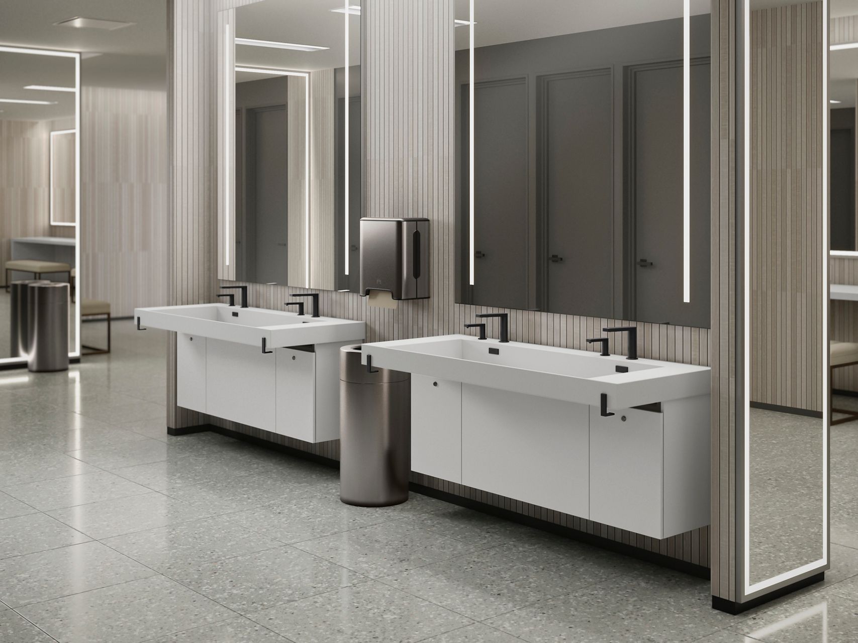 A spacious white commercial sink with multiple stations, designed for easy use in high-traffic restrooms. It features integrated soap dispensers and a streamlined, modern aesthetic.