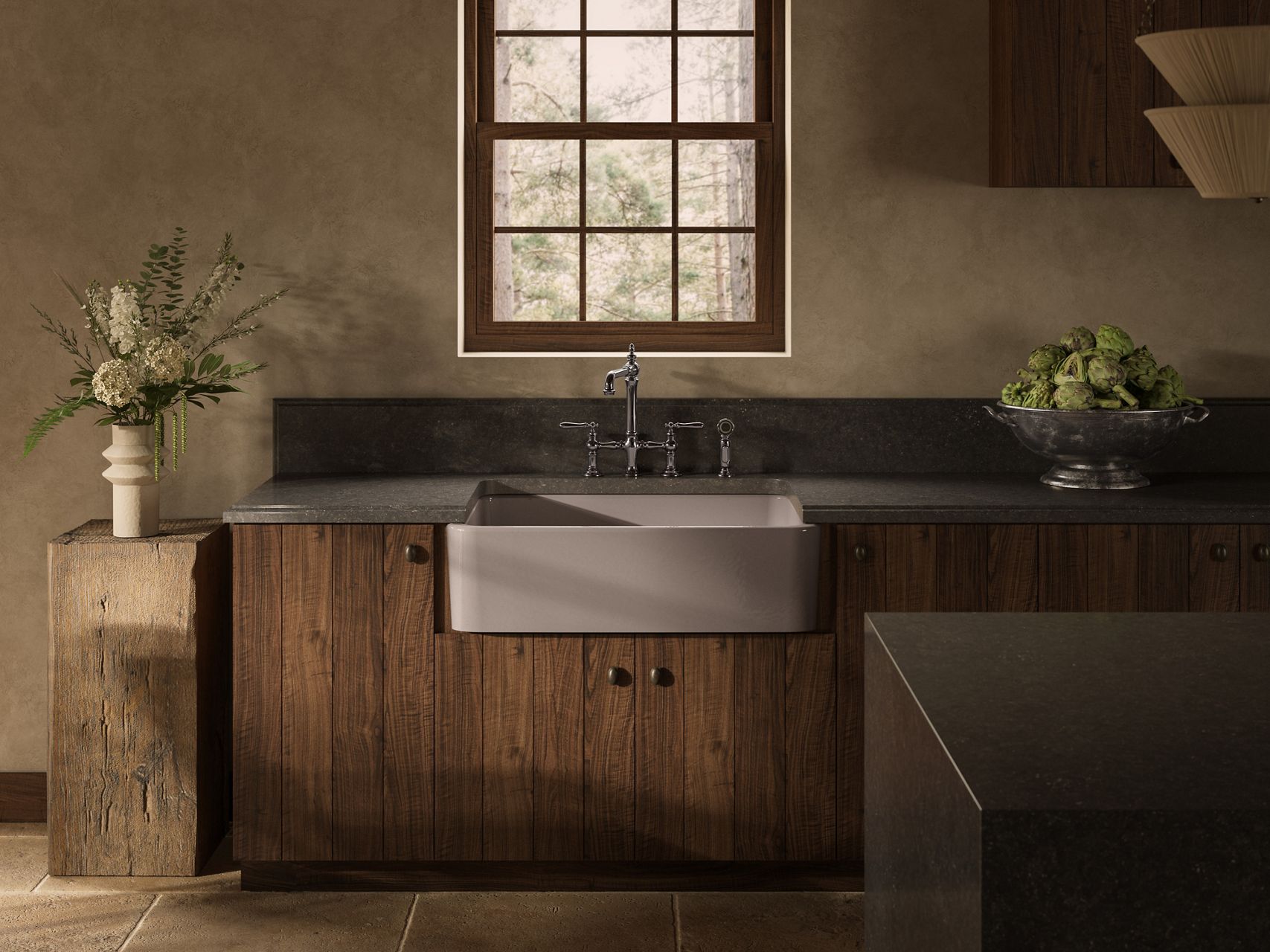 Taupe farmhouse sink with classic bridge faucet and dark backsplash