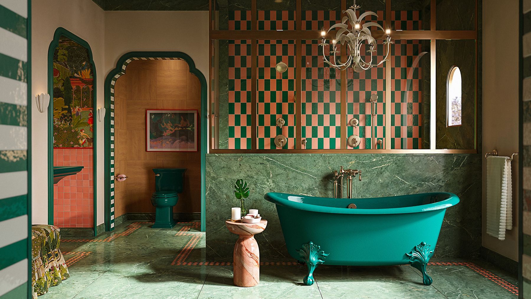 Glamorous green and peach bathroom with brushed bronze finishes, a bold green toilet and bathtub, and vintage accents.