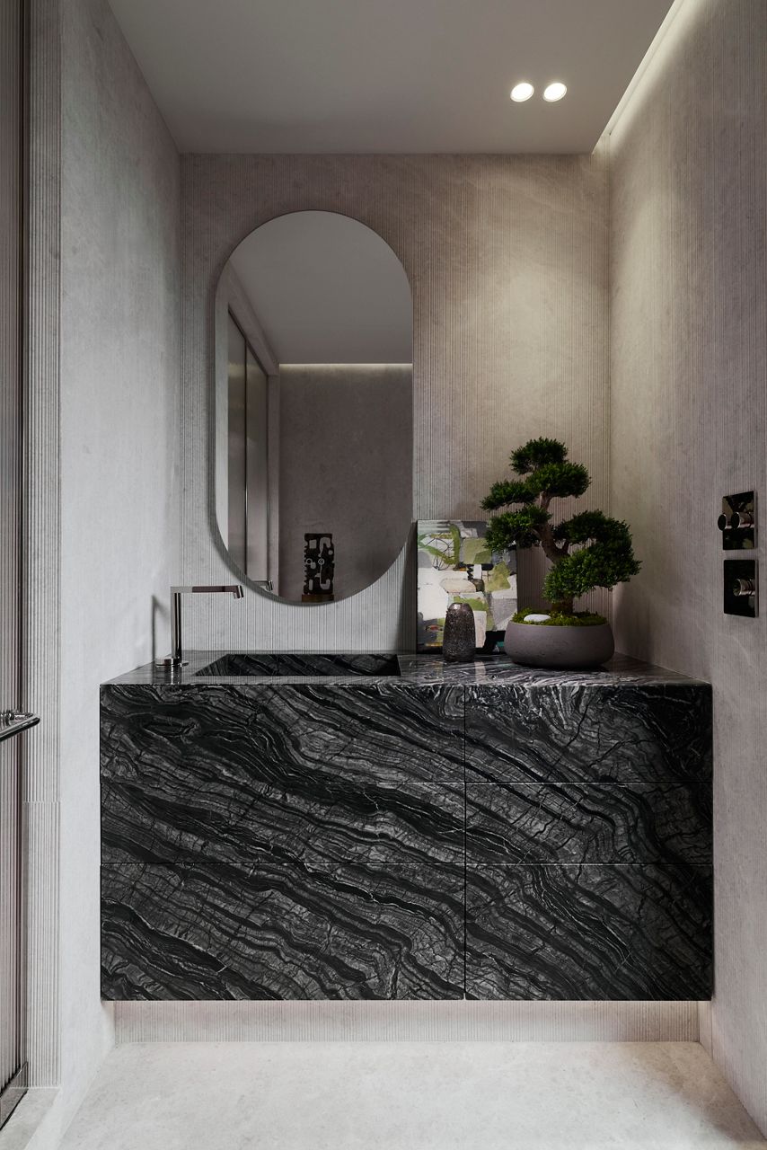 Modern bathroom with a striking black marble vanity and polished nickel faucet.