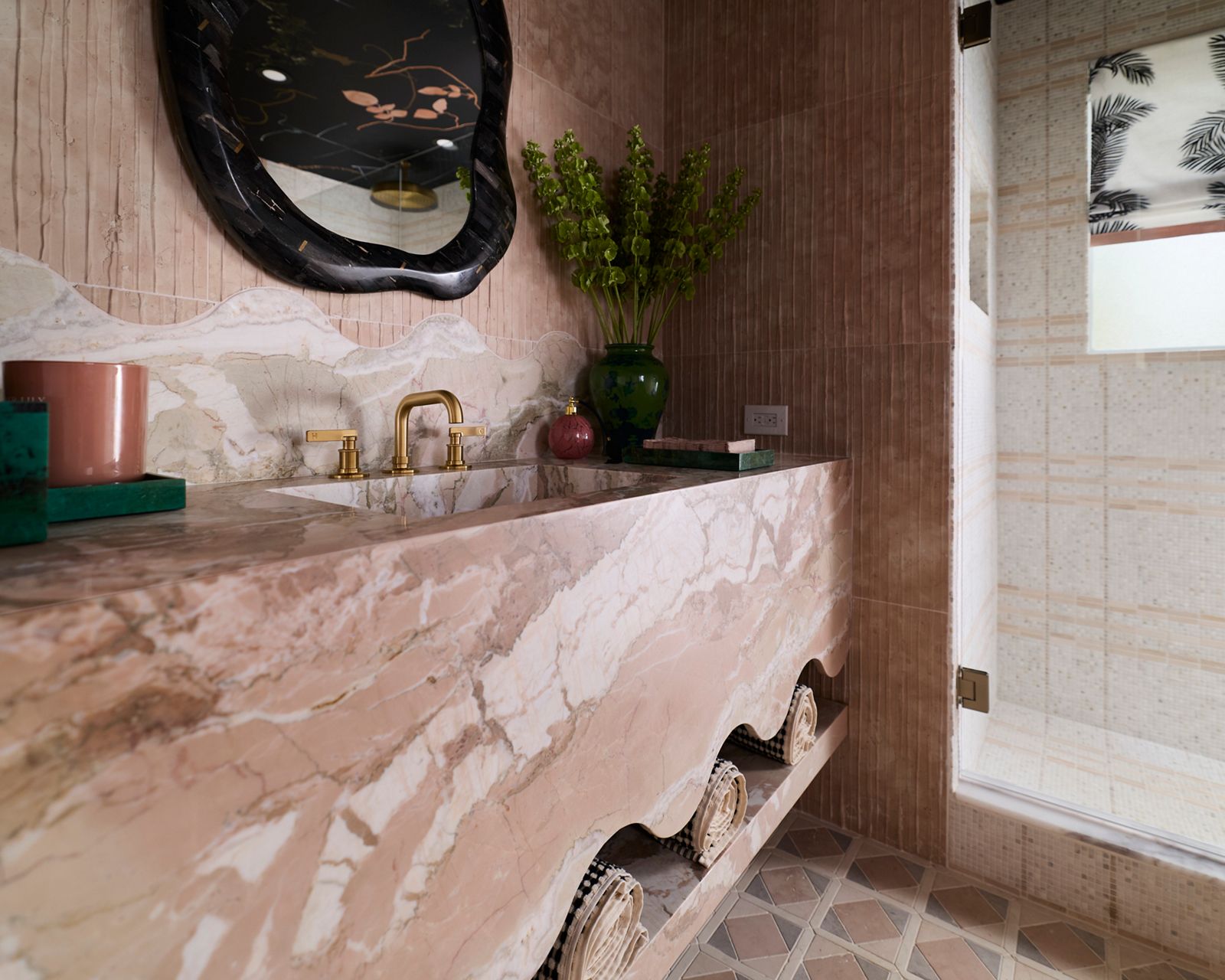 Colorful countertop and sink made from calacatta marble in a charming bathroom.