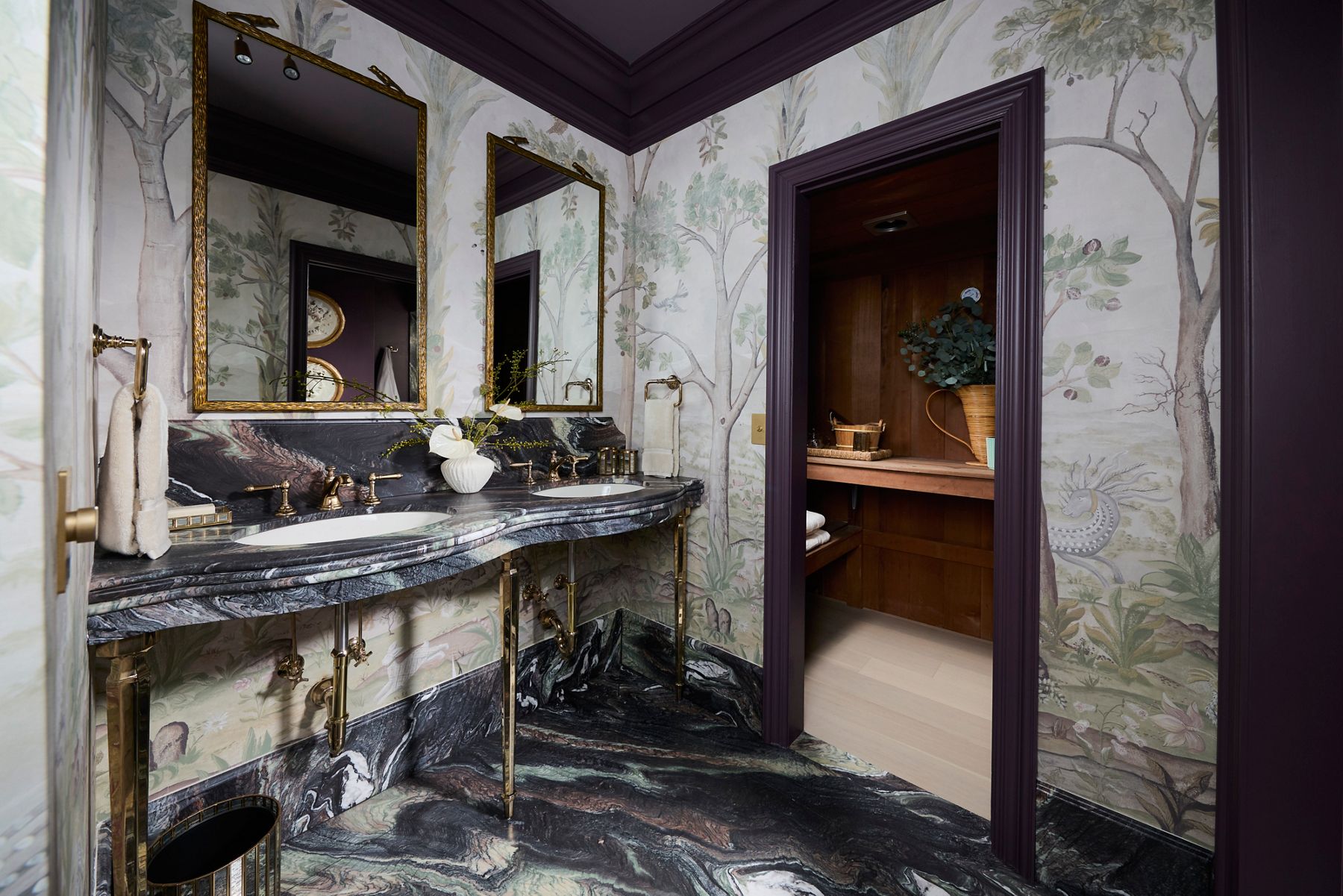 Refined jewel-toned bathroom with unique blue stone vanity and floor and Vibrant French Gold finishes.