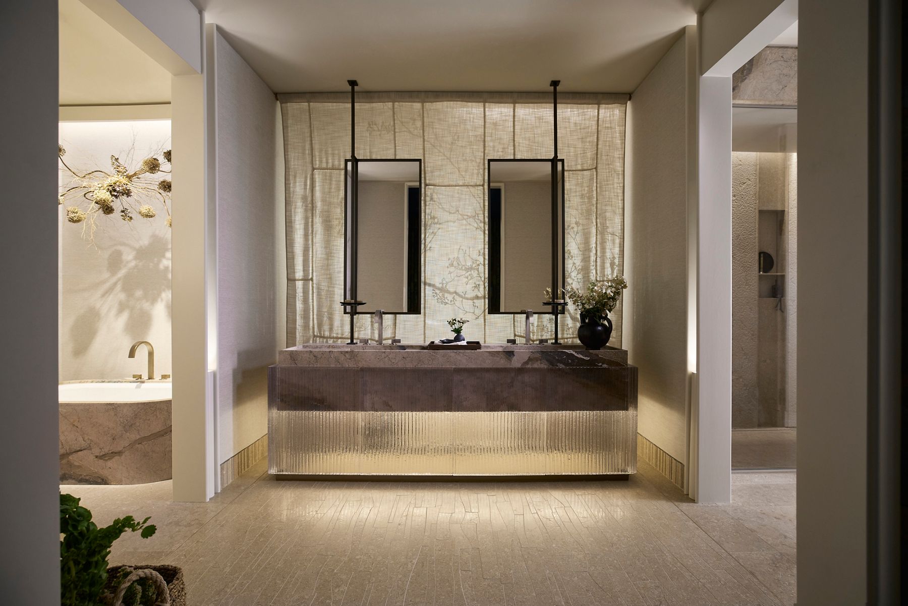 Serene luxury bathroom with a floating double vanity, two suspended rectangular mirrors, textured stone surfaces, and soft integrated lighting.