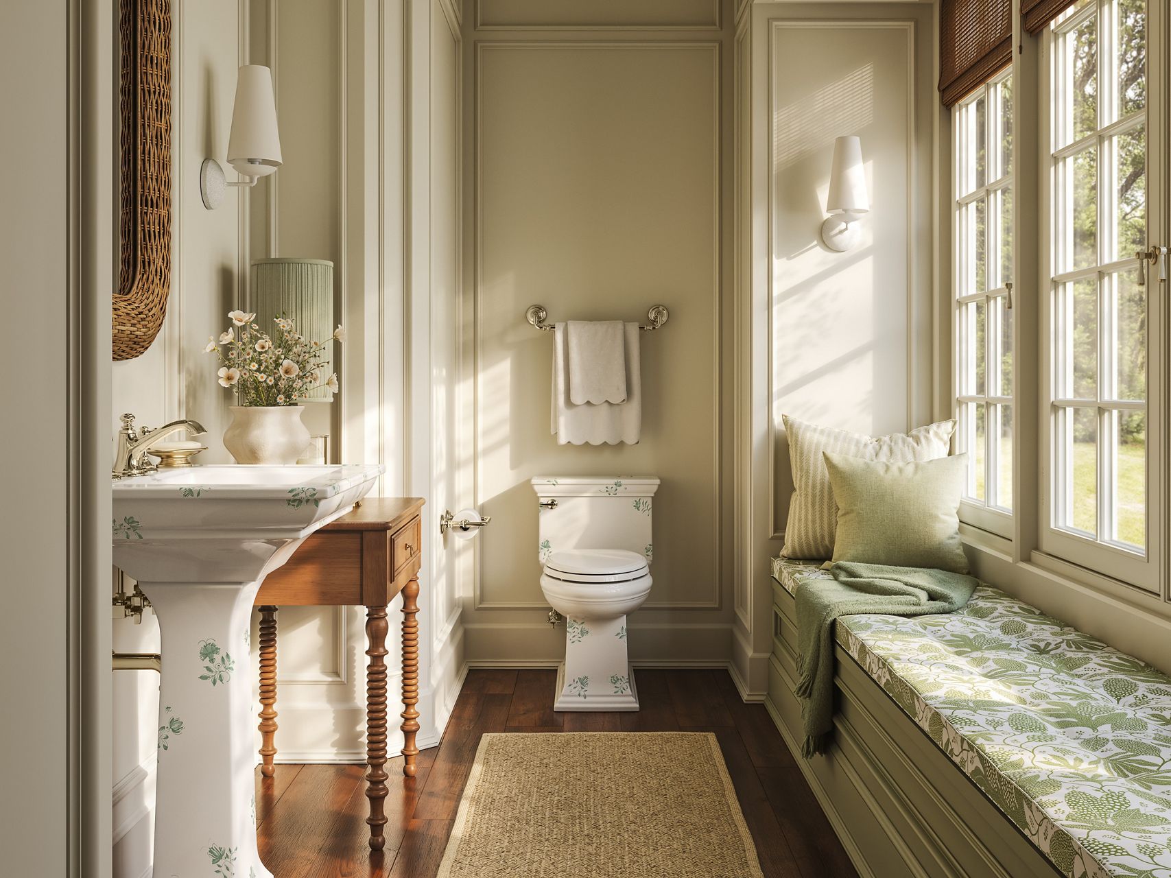 AERIN Memoirs Console Table Sink and Memoirs Toilet in AERIN Green, paired with a polished brass widespread faucet in an elegant, warmly lit bathroom.