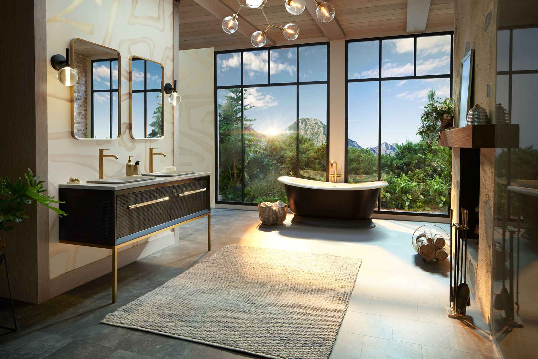 A black KOHLER Artifacts freestanding bath makes a statement in a large bathroom with Envio double vanity, Essential mirrors, and floor to ceiling windows with mountain views.