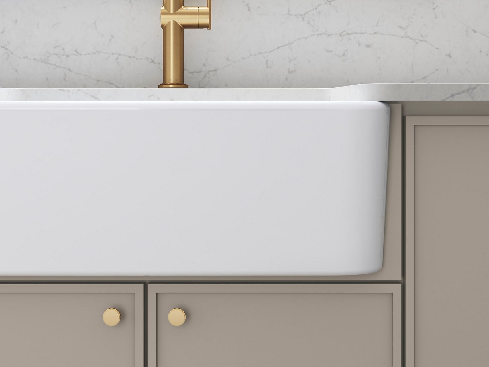 Brushed gold pull-down kitchen faucet with white farmhouse sink and marble backsplash