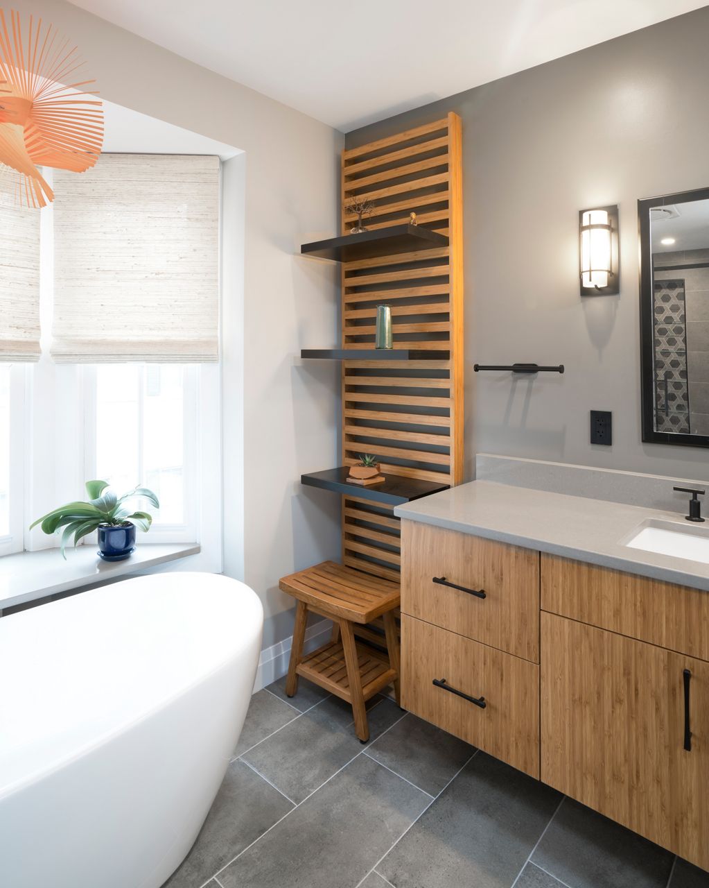 Renovated bathroom with wood vanity and slatted shelving.