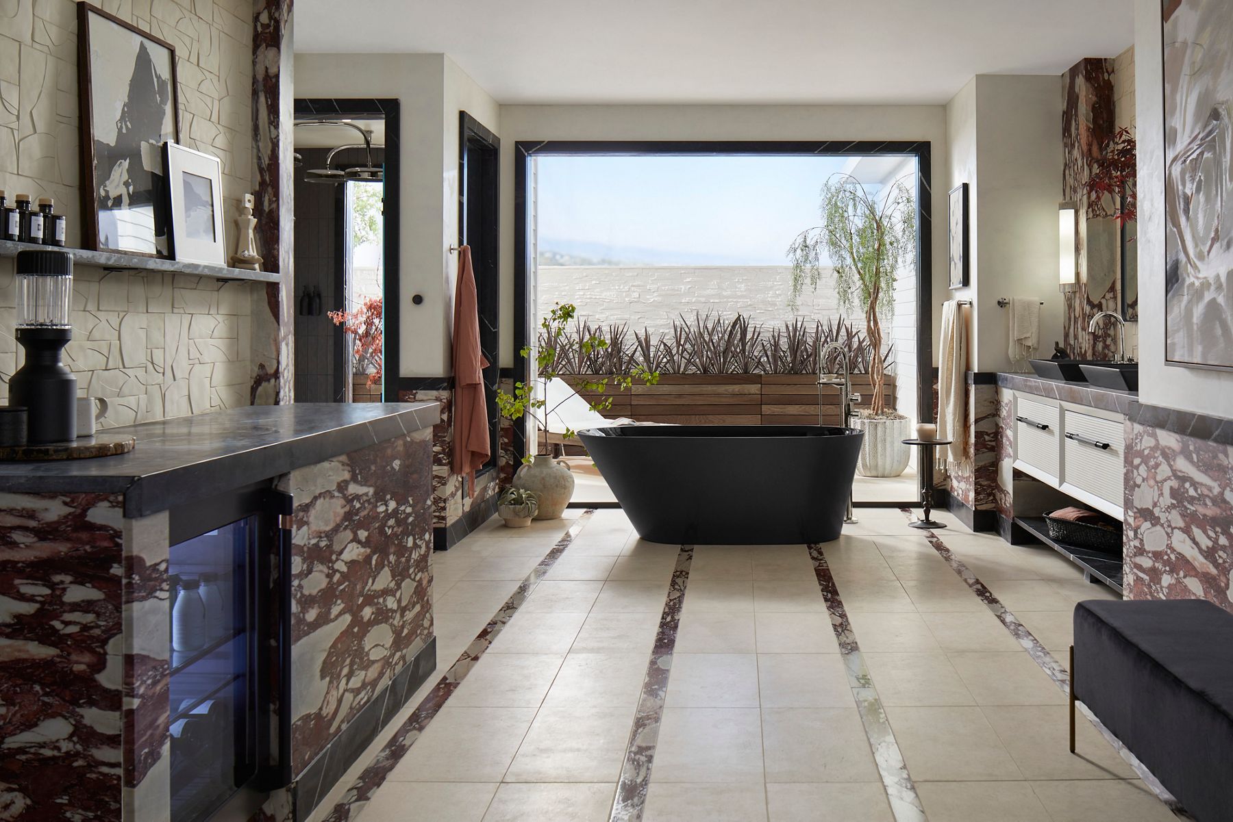 Spacious luxury bathroom with a black freestanding bathtub, stone fireplace, dual vanities, and expansive windows overlooking a scenic outdoor view.