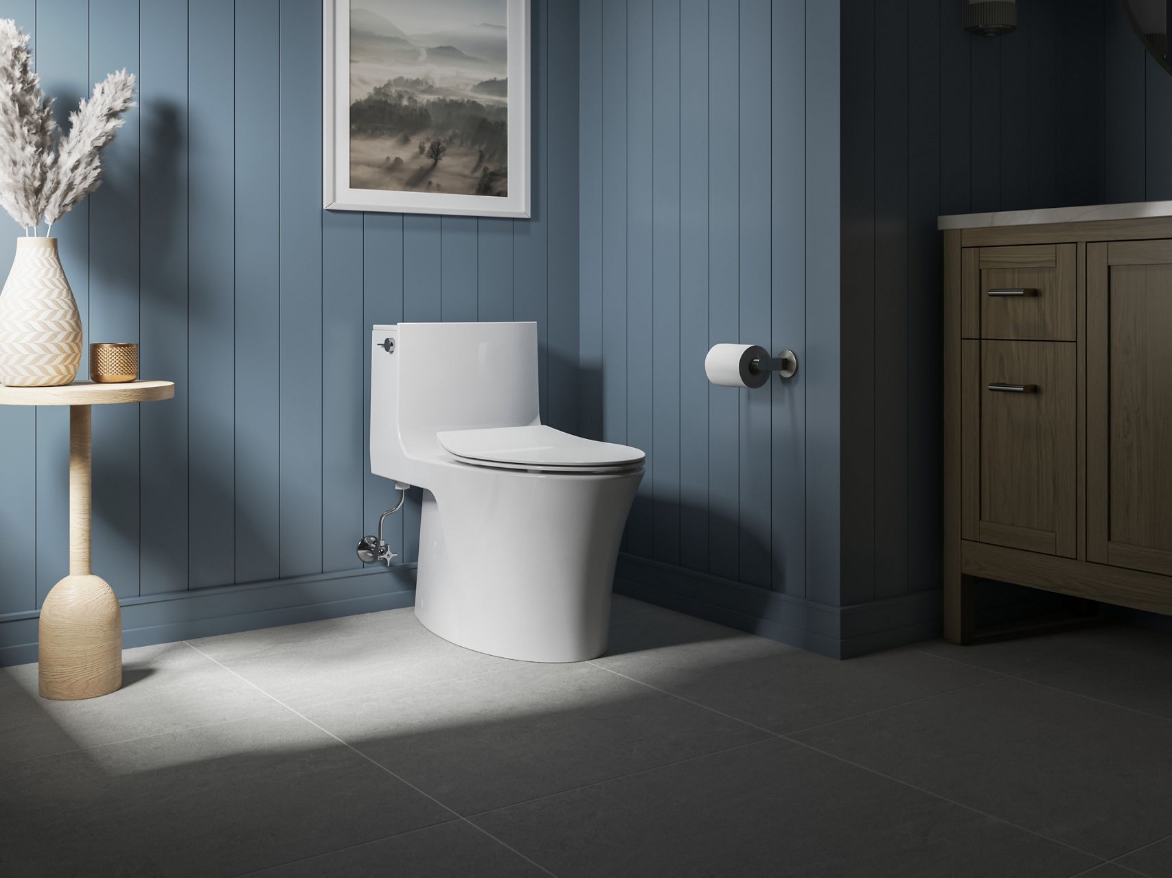 Contemporary white toilet in coastal blue paneled bathroom with light wood decor.