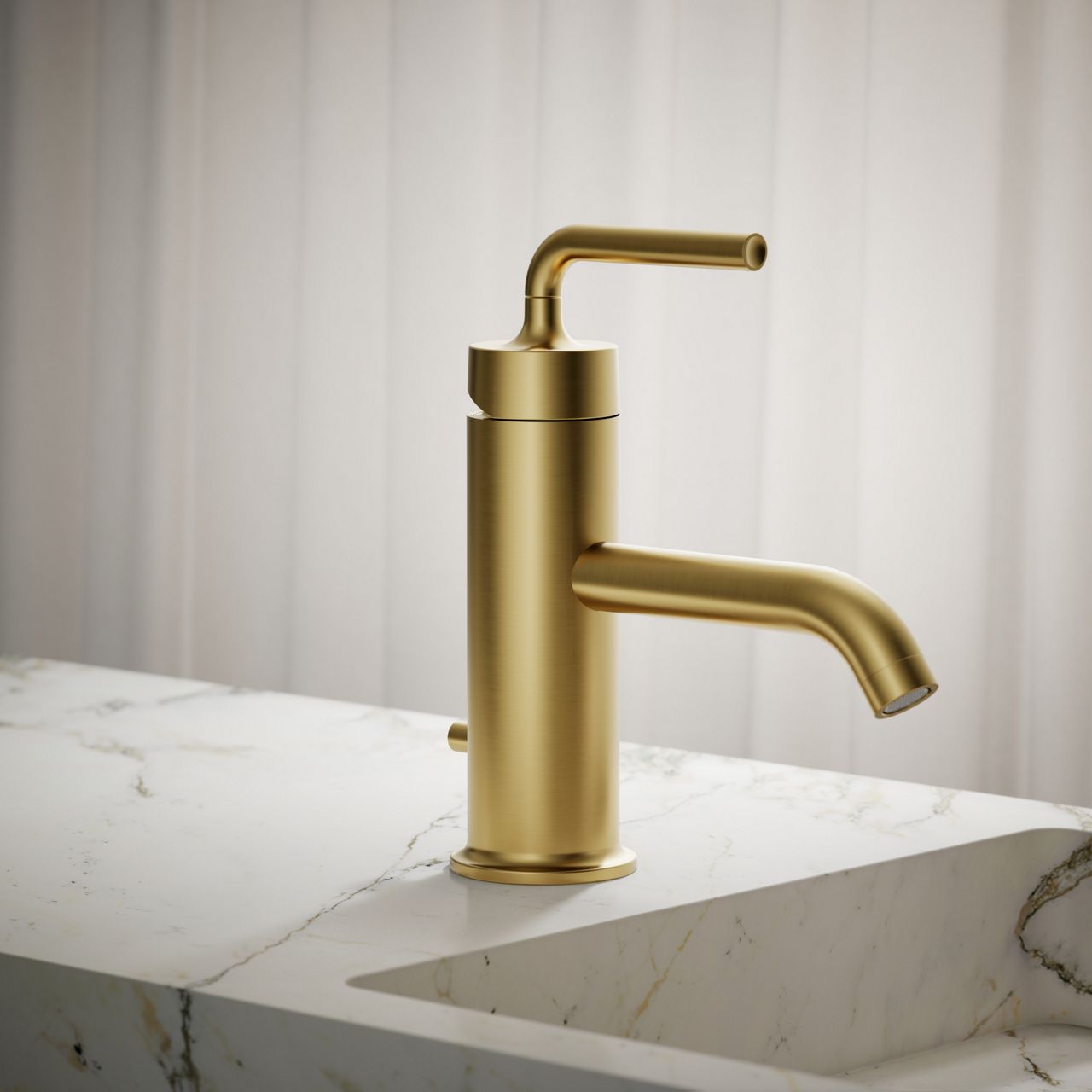 Single-handle brushed gold bathroom faucet on white marble sink