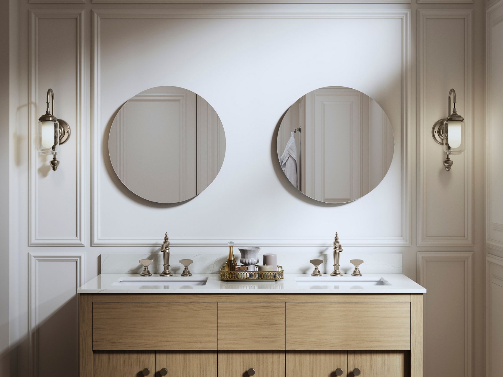Double round mirrors with brass sconces above a light wood vanity in a classic bathroom setting.