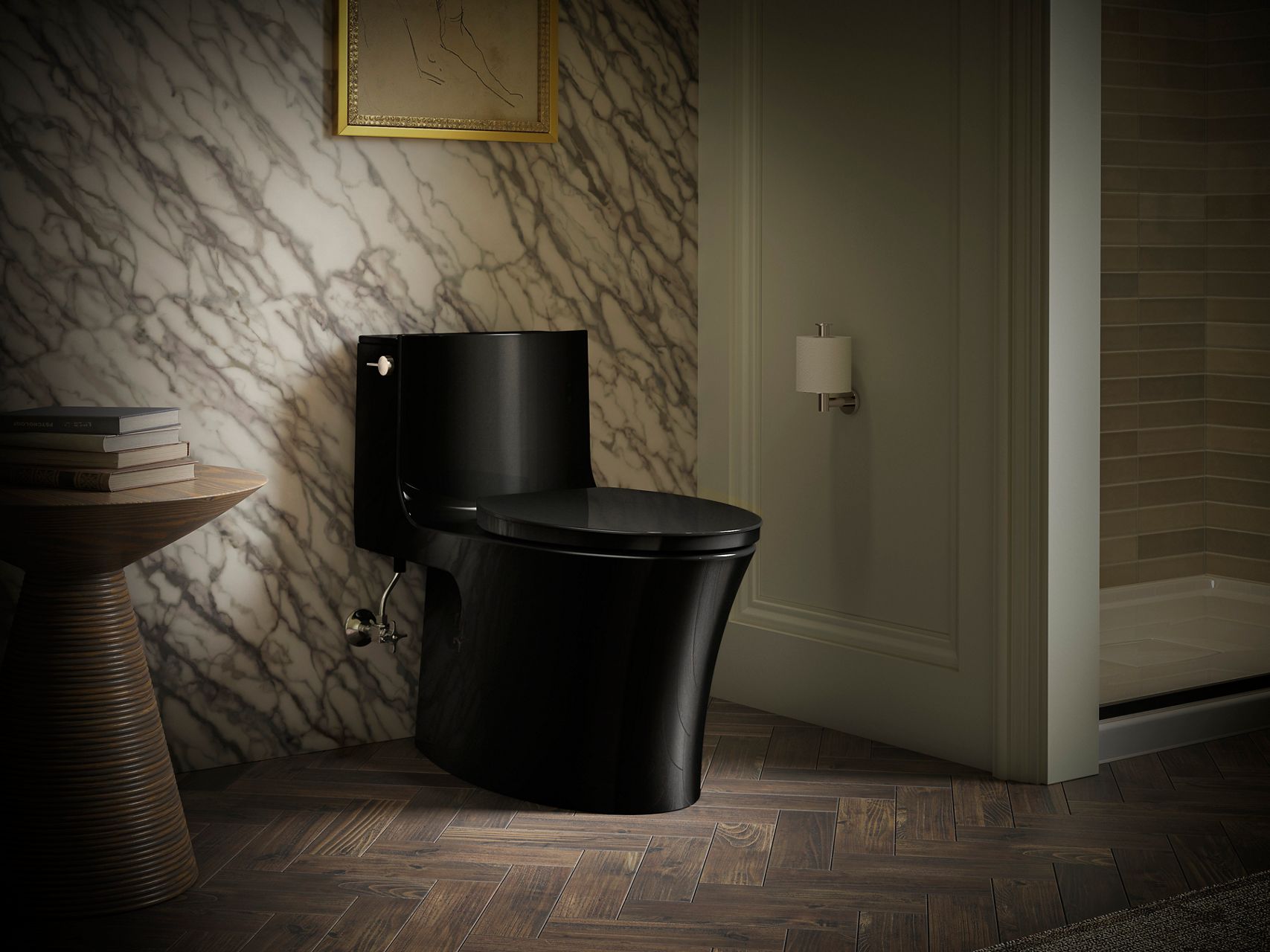 Luxury black toilet in marble and gold accented powered room.