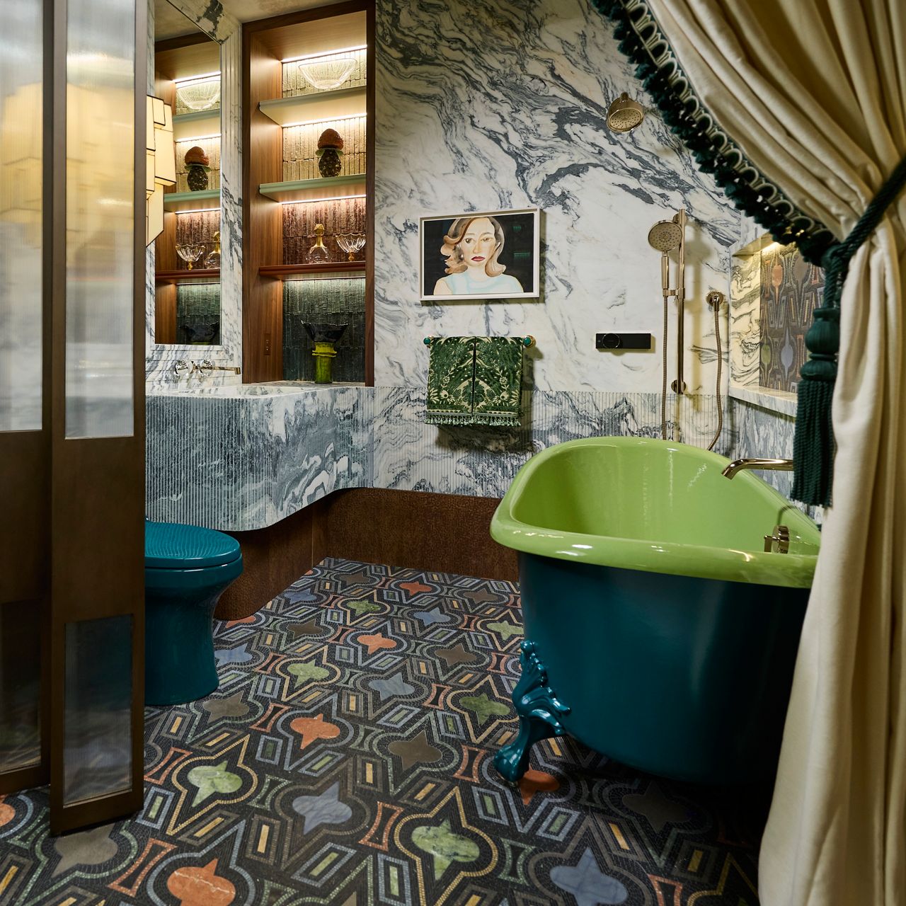 Eclectic bathroom with a green freestanding tub, patterned tile floor, mixed textures, and a glass partition with layered wallpaper and decor.