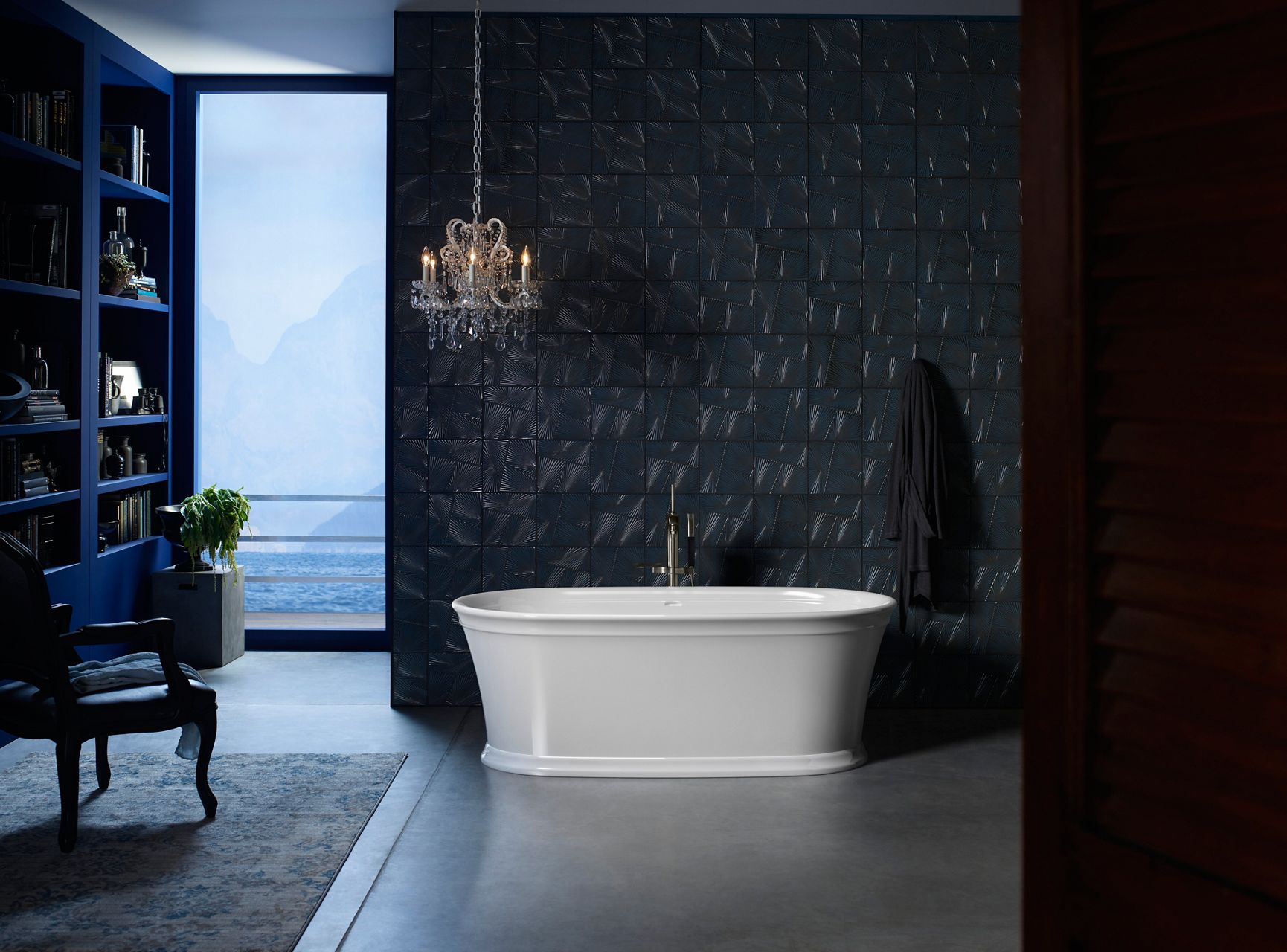 A Memoirs freestanding bath in a room with dark walls.