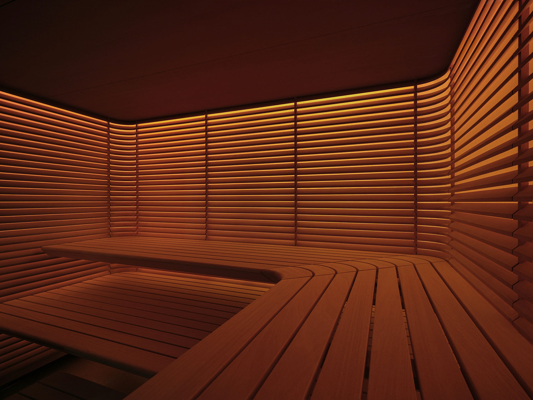 A warm, inviting sauna interior with wooden slats covering the walls and benches, illuminated by soft ambient lighting.