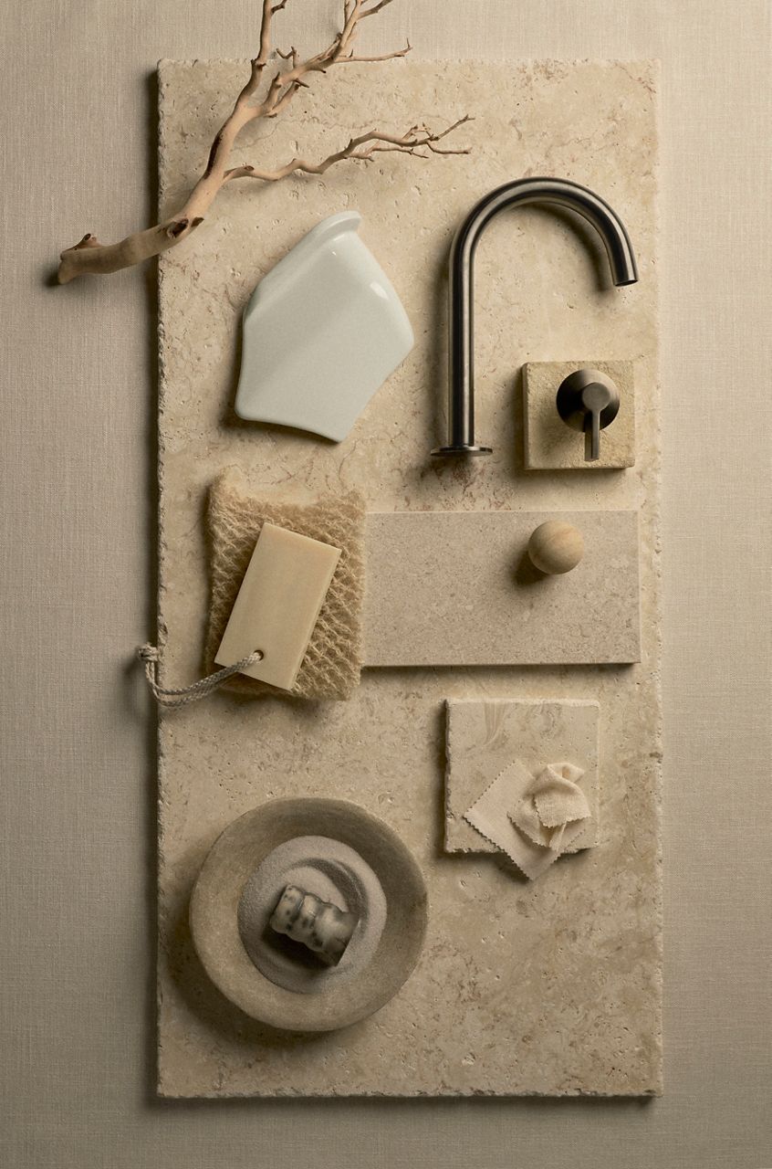 Matte black faucet with artisan soap and neutral-toned background