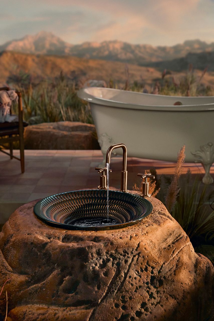 White freestanding bathtub with desert landscape background