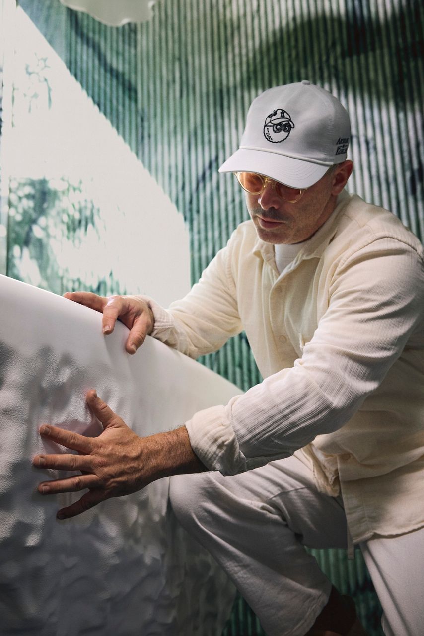 Daniel Arsham looking at the side of a bathtub.