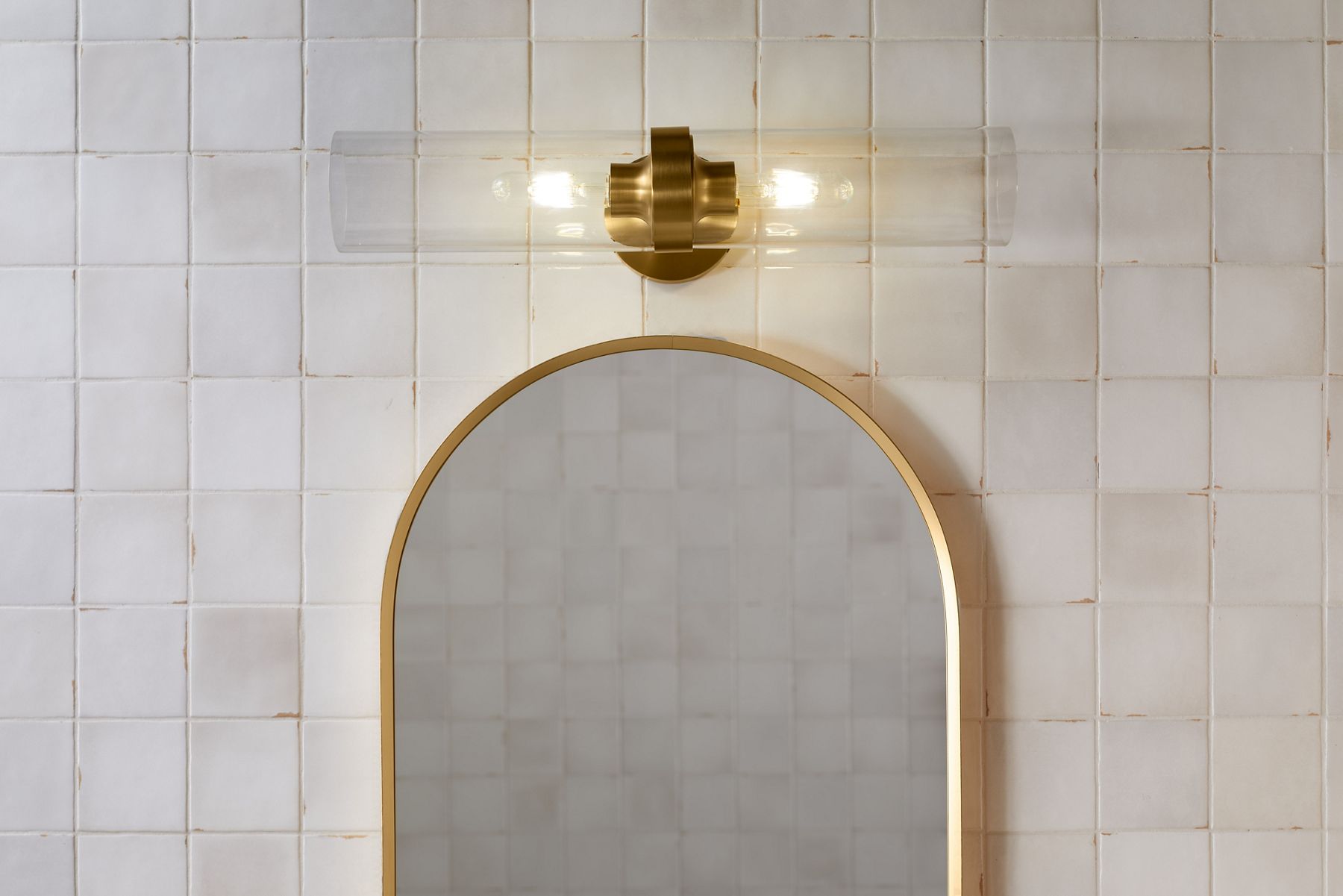 A Purist two-light sconce in Brushed Moderne Brass.