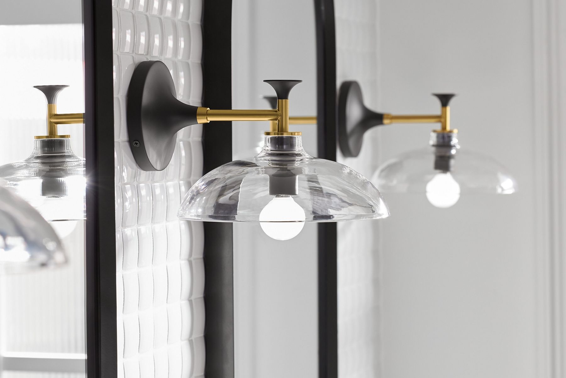 Two Tone sconces in Matte Black and Brushed Modern Brass.