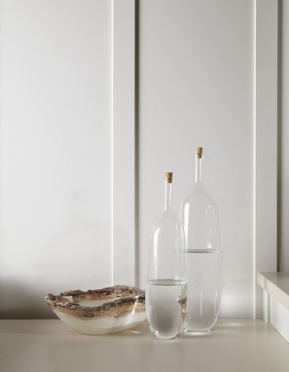 A moodboard featuring items that add sparkle and add dimension to a white-on-white bathroom