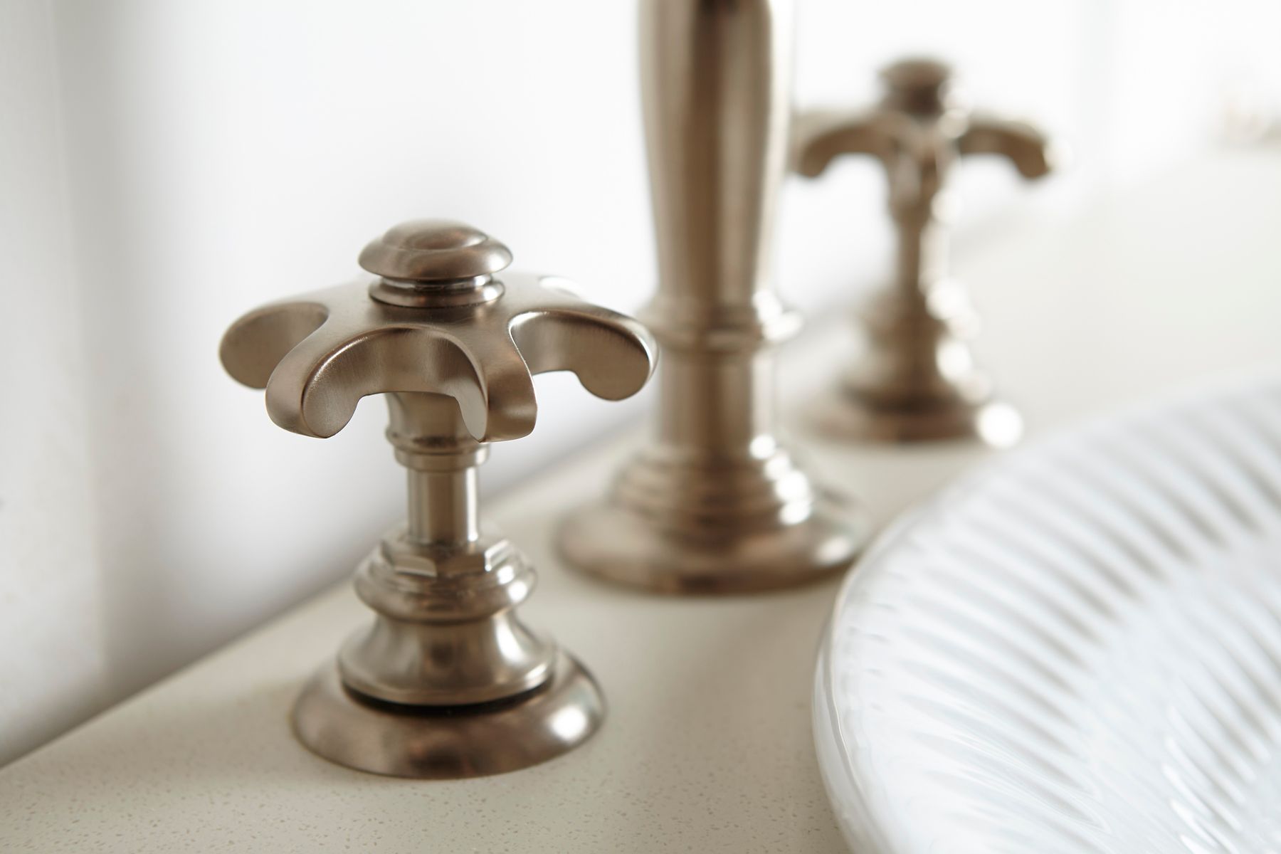 A moodboard featuring items that add sparkle and add dimension to a white-on-white bathroom