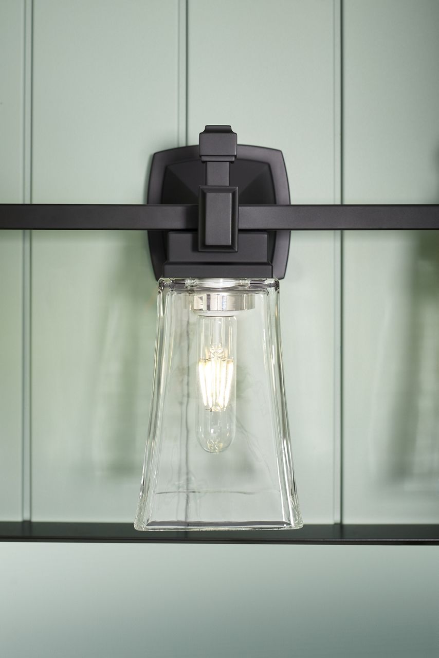 Close up of a Riff three-light sconce in Matte Black.