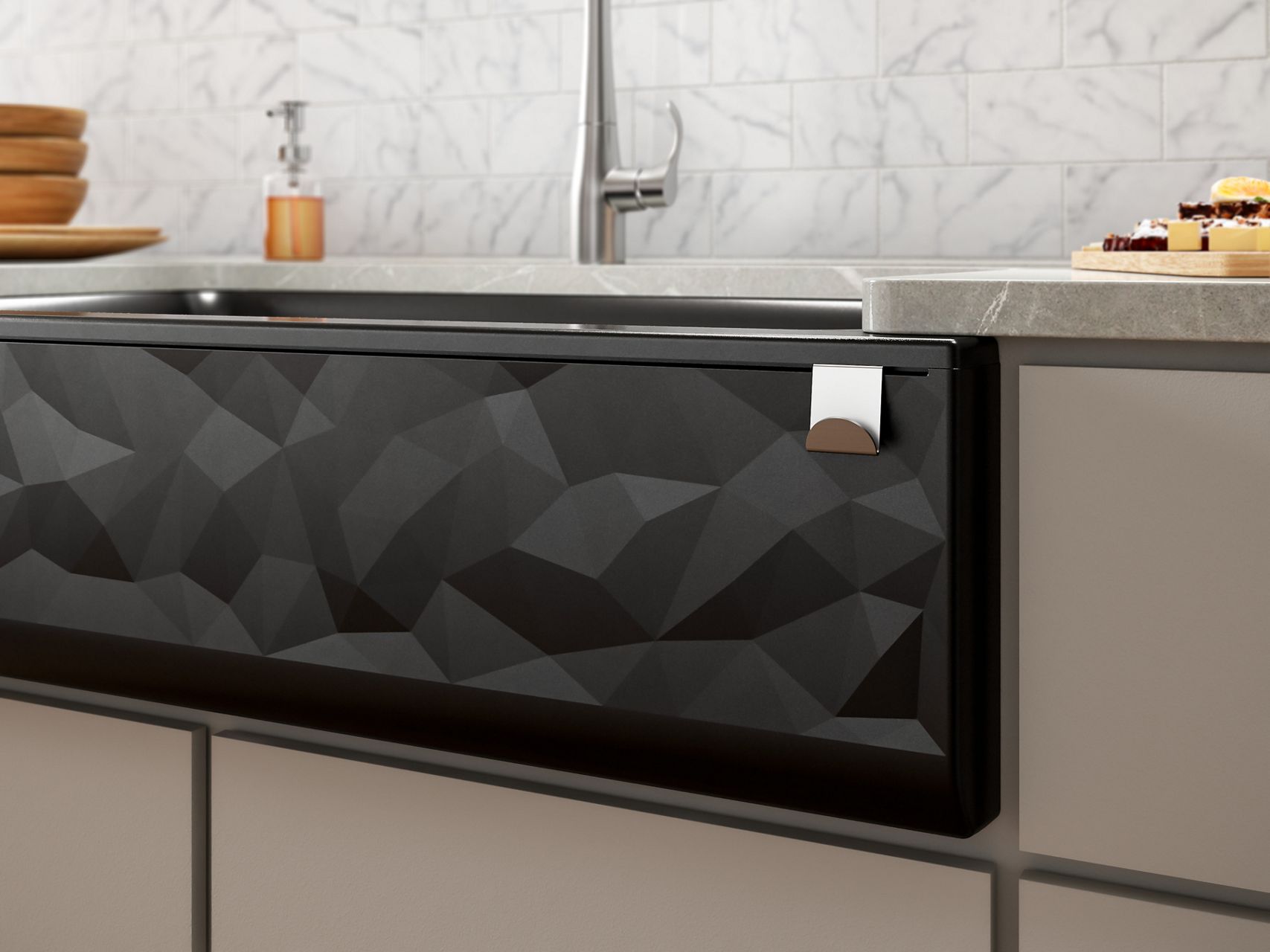 Stainless steel farmhouse kitchen sink with a stainless steel pull-out faucet in an off-white kitchen cabinet with a tiled back splash of varying shades of light gray.