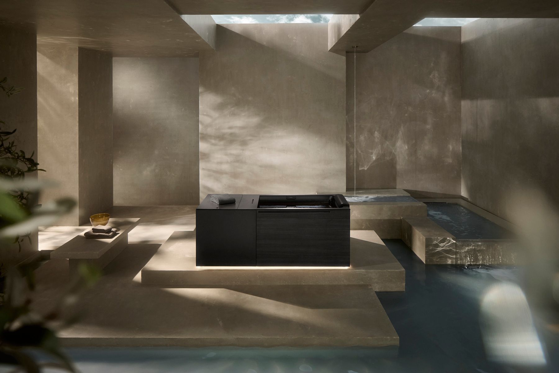 Kohler Ice Bath in a serene spa environment featuring sky lights and pools of clear water.