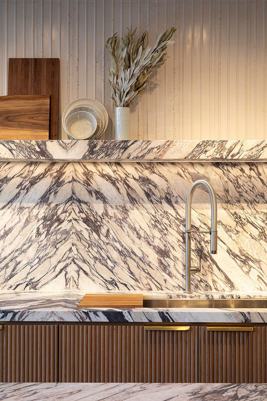 Ann Sacks Denver showroom interior view of marble slab backsplash with decor on shelf