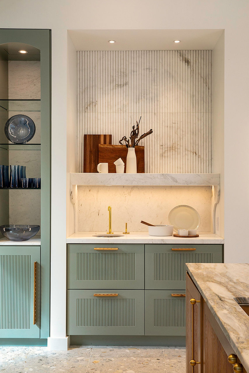 Kitchen interior with stone backsplash and green kitchen cabinets