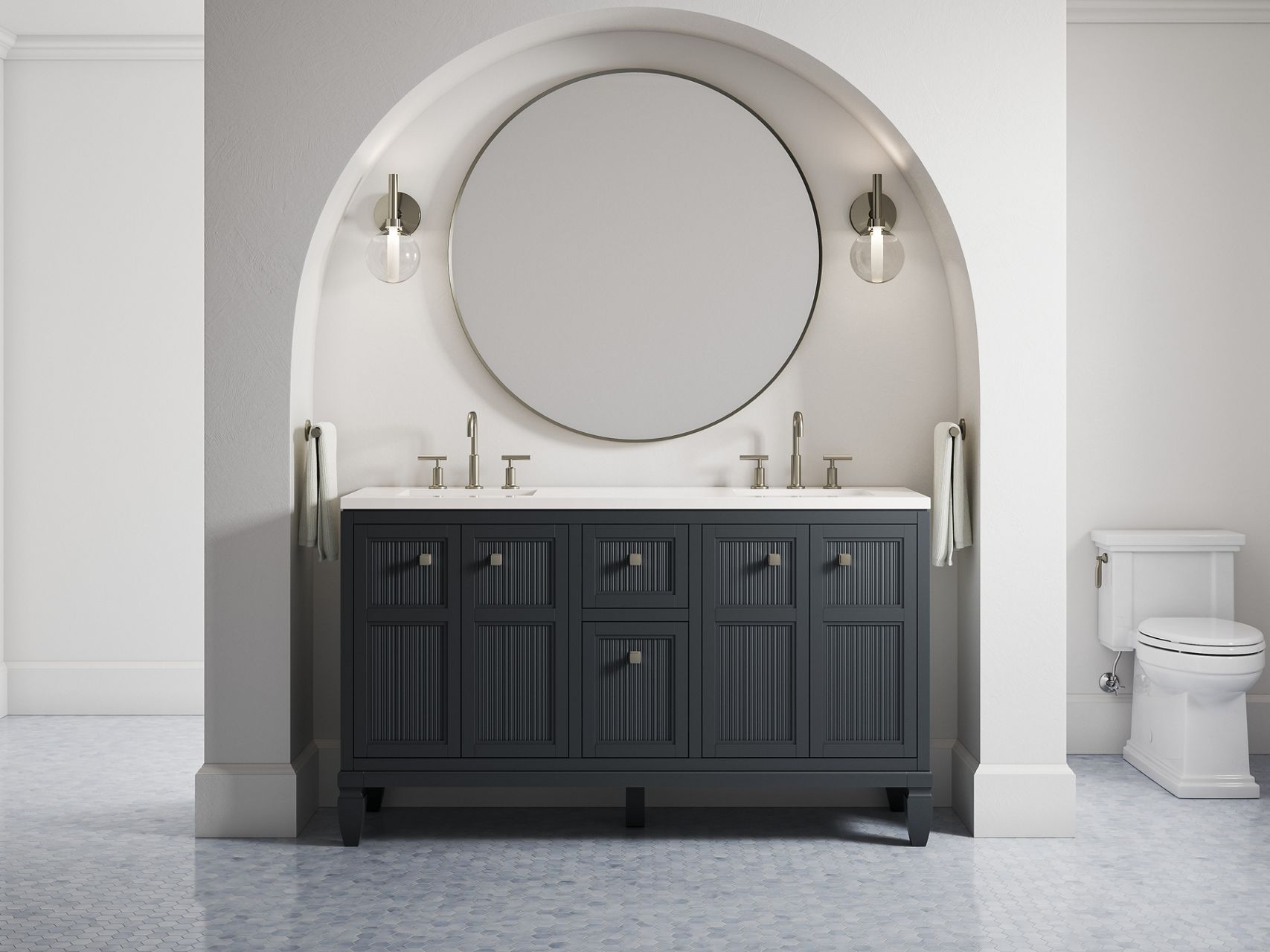 A 60-inch Hearthhaven vanity in slate grey along with a round mirror and two sconce lights in an off-white alcove with a rounded top.