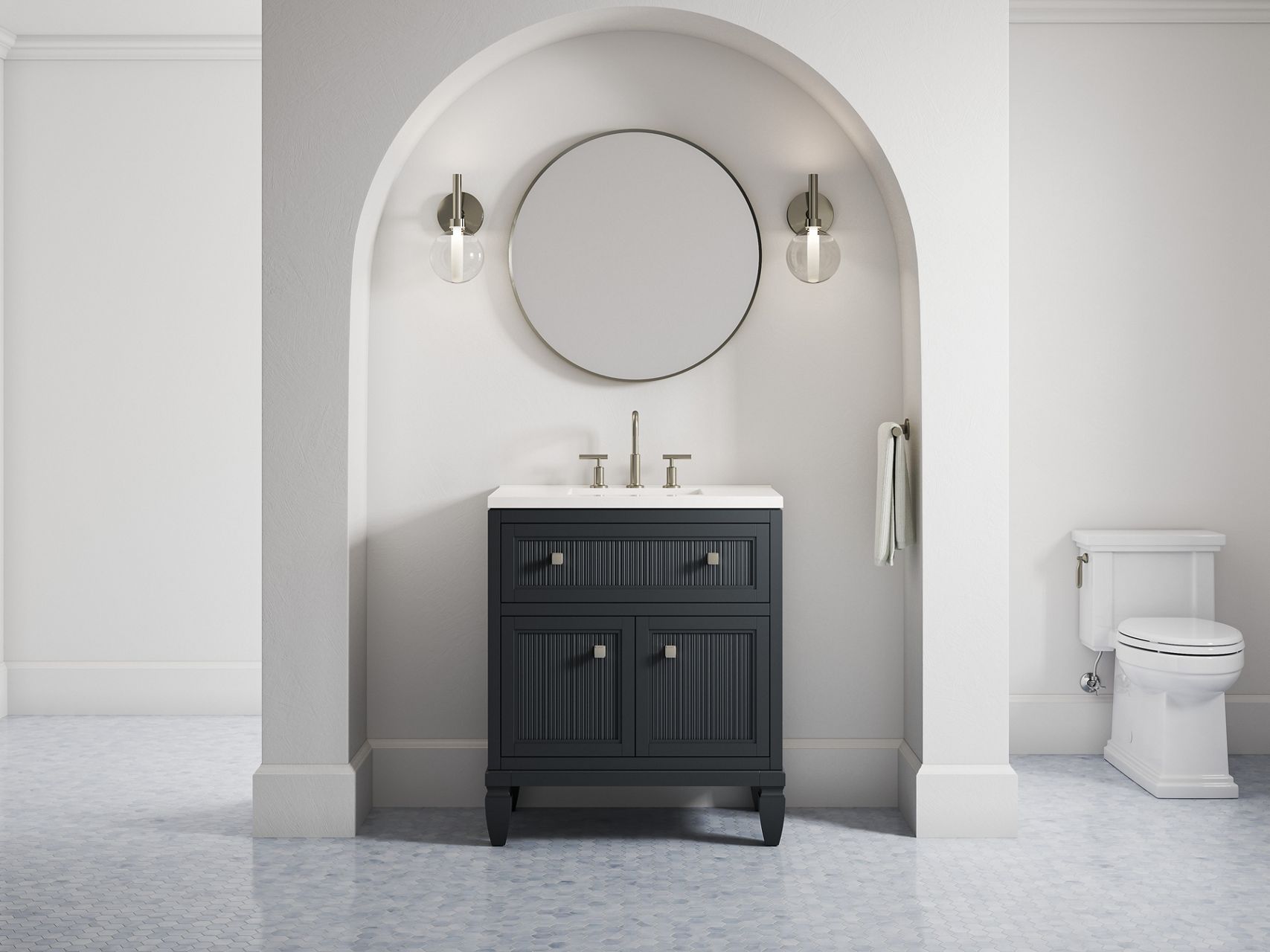 A 2-inch Hearthhaven vanity in slate grey along with a round mirror and two sconce lights in an off-white alcove with a rounded top.