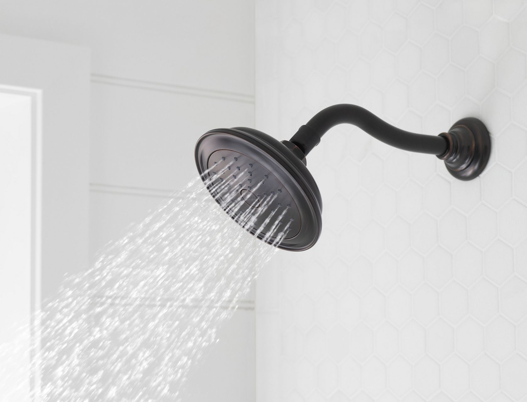 Water flows from a showerhead with traditional lines in Black Matte finish.