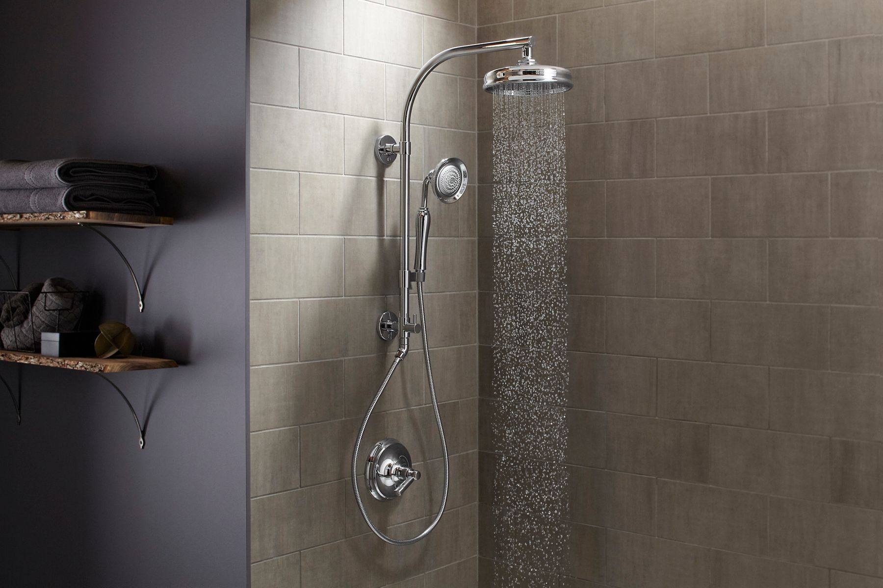 A Hydrorail shower with a rainhead pouring water and a handshower.