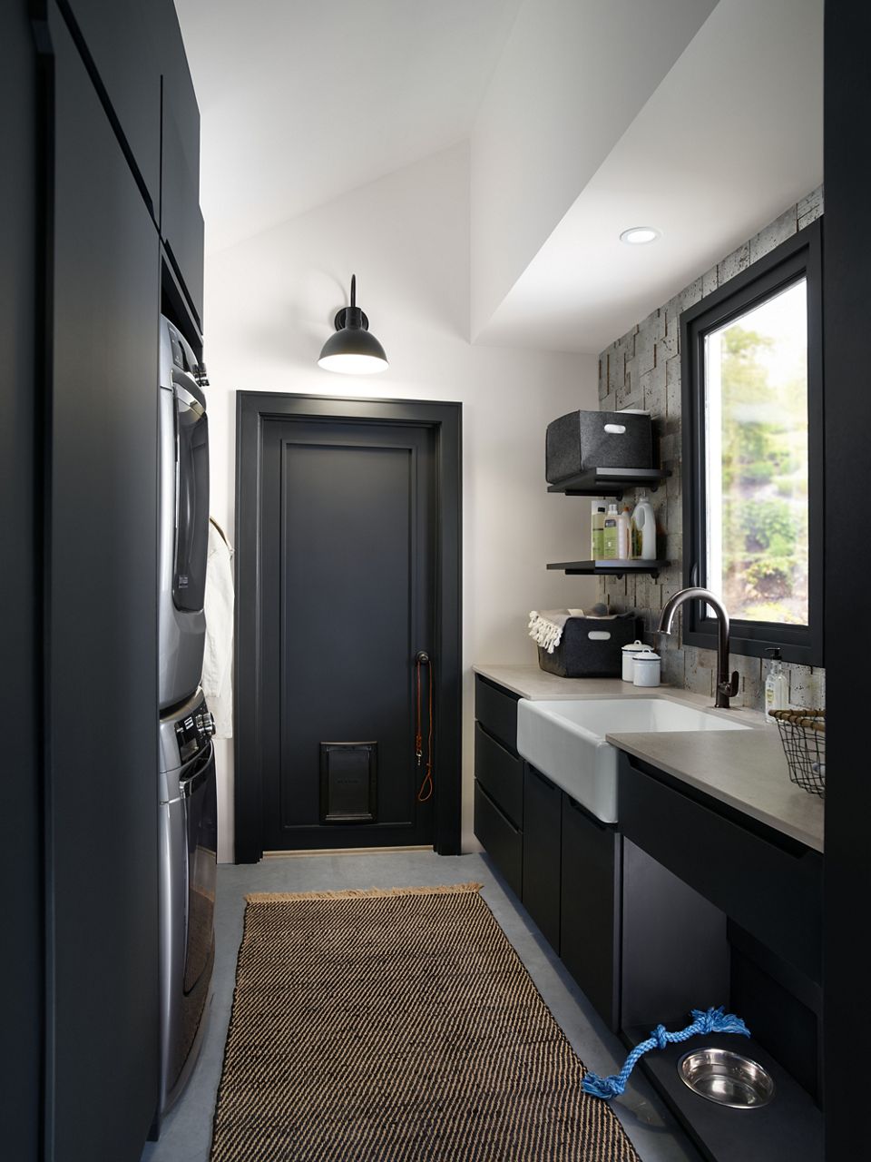 High contrast utility room with KOHLER farmhouse sink and storage shelves