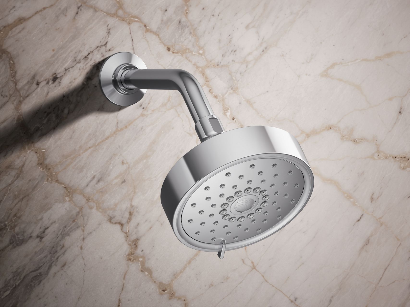 Contemporary chrome shower head with a sleek curved design mounted on a shower arm.