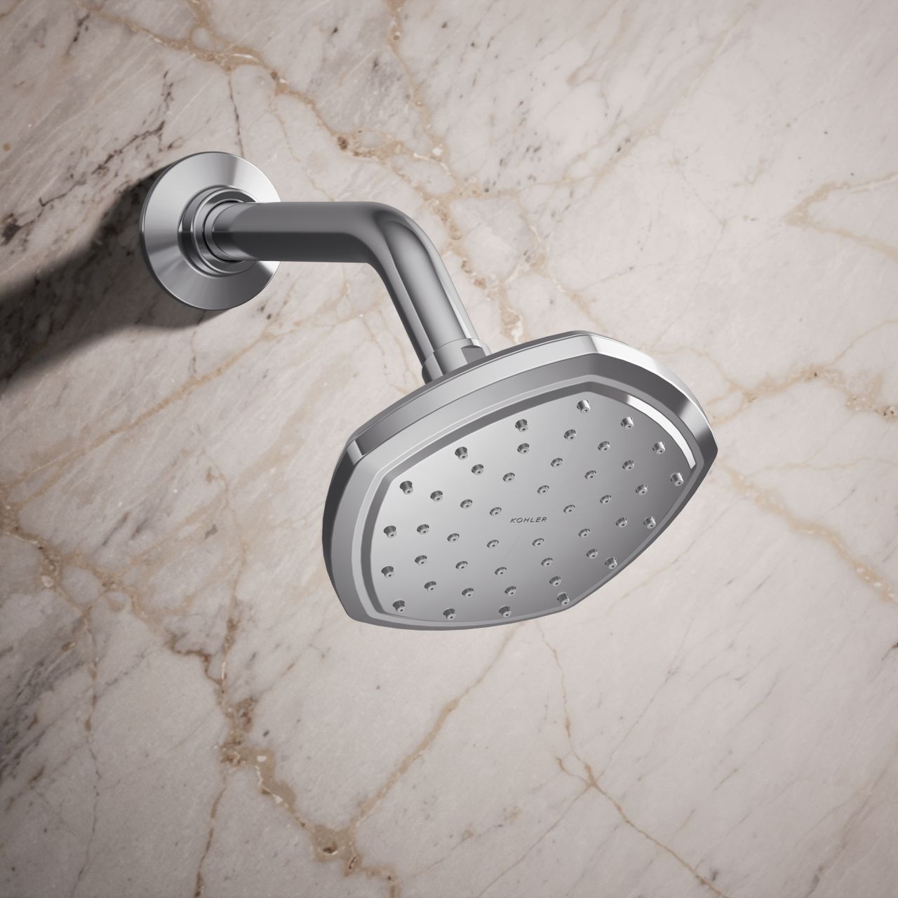Transitional-style chrome shower head with soft geometric edges mounted on a shower arm